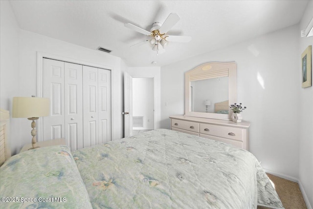 bedroom featuring carpet, ceiling fan, and a closet