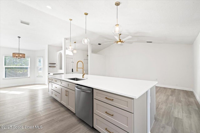 kitchen featuring sink, decorative light fixtures, gray cabinets, and stainless steel dishwasher