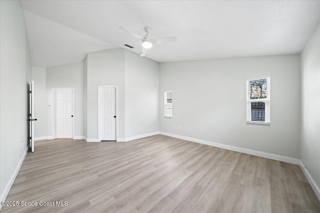 unfurnished room with vaulted ceiling, ceiling fan, and light wood-type flooring