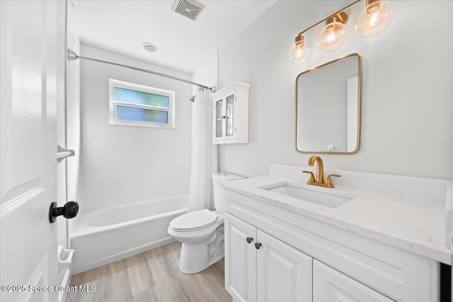 full bathroom with hardwood / wood-style flooring, vanity, shower / tub combo, and toilet