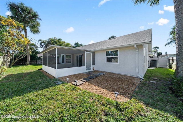 back of house with cooling unit, a yard, and a sunroom