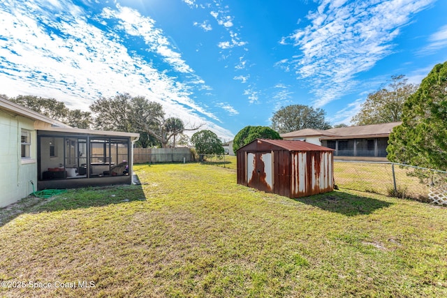 view of yard featuring a shed and a sunroom