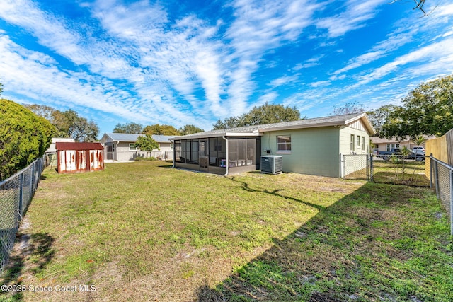 back of house with cooling unit, a sunroom, and a lawn