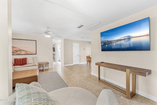 living room featuring ceiling fan, a textured ceiling, and light tile patterned floors