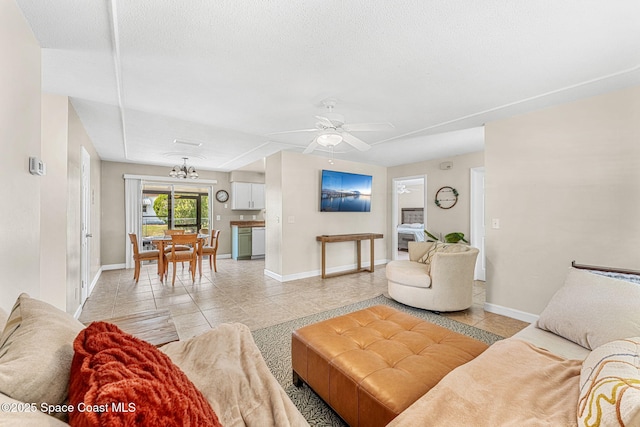 living room with ceiling fan, a textured ceiling, and light tile patterned floors