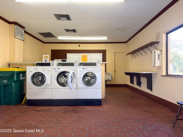 laundry room featuring crown molding and a textured ceiling