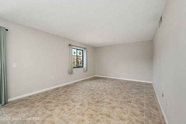 empty room with a textured ceiling