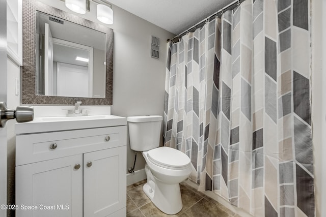 bathroom featuring vanity, walk in shower, tile patterned floors, and toilet