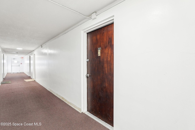 hallway featuring light colored carpet