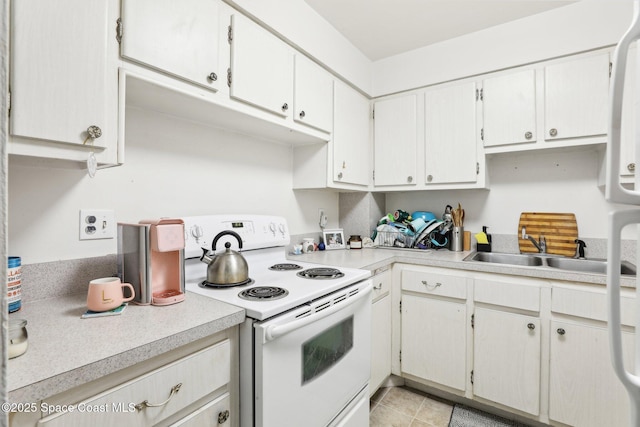 kitchen featuring white cabinetry, sink, and white electric range oven