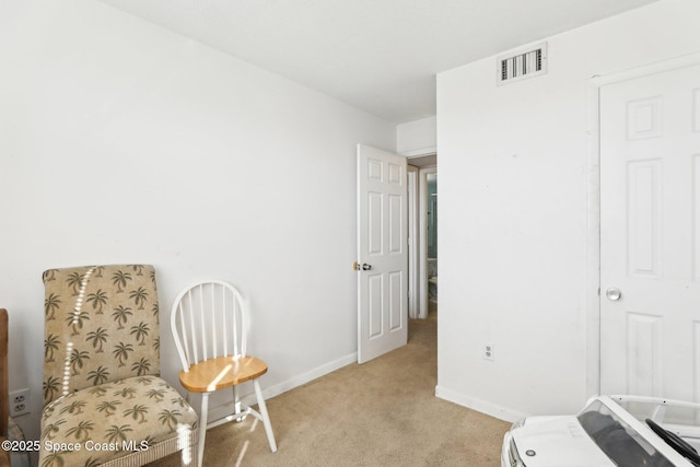 sitting room featuring light carpet