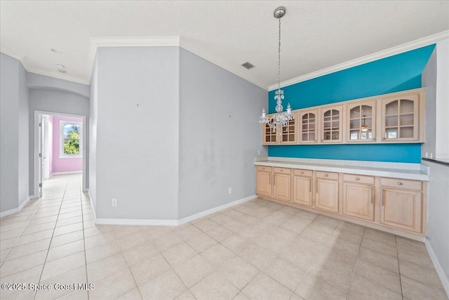 unfurnished dining area featuring light tile patterned floors and crown molding