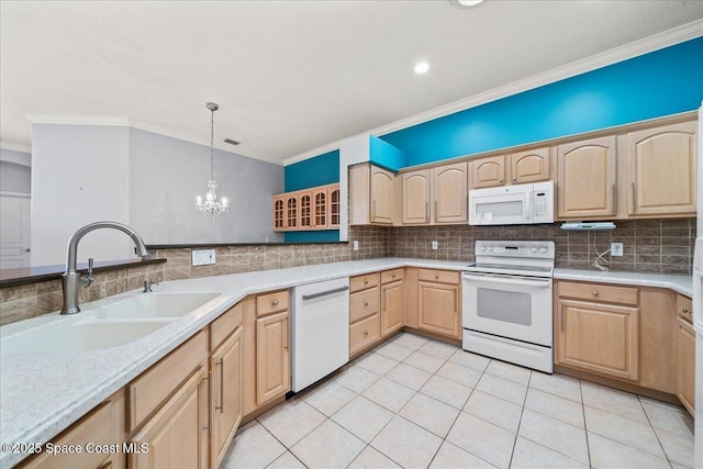 kitchen featuring white appliances, light brown cabinetry, sink, and hanging light fixtures