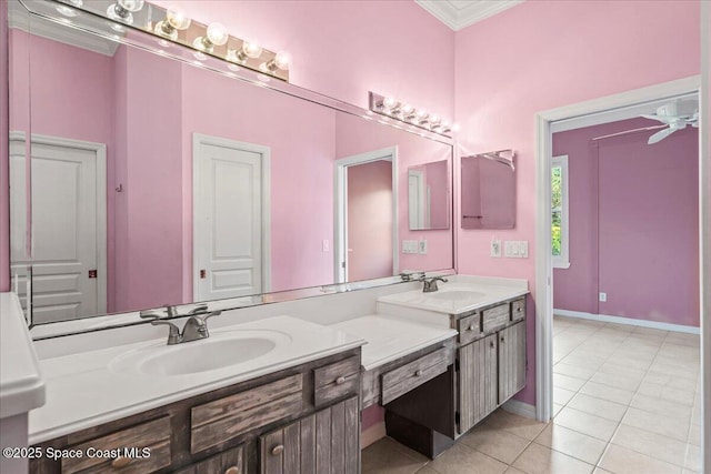 bathroom with ceiling fan, ornamental molding, vanity, and tile patterned floors