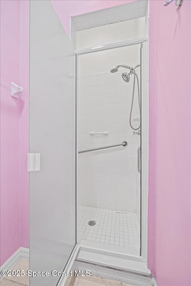 bathroom featuring a shower with shower door