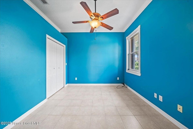 tiled spare room with crown molding and ceiling fan