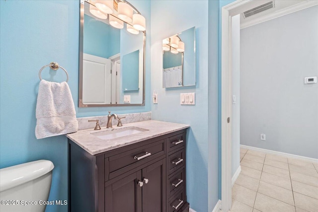 bathroom featuring tile patterned floors, vanity, and toilet