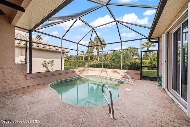 view of swimming pool with a patio area, glass enclosure, and a jacuzzi