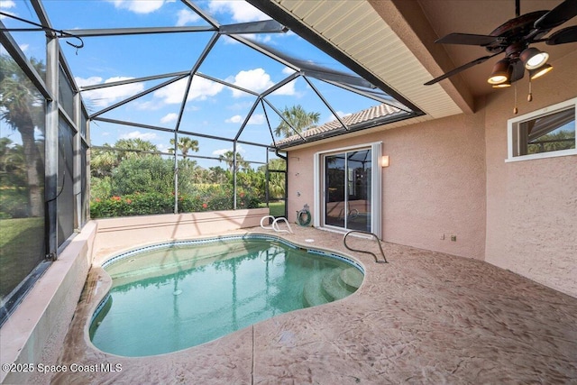 view of swimming pool with a lanai, a patio, and ceiling fan