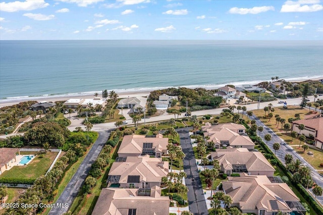 aerial view with a water view and a view of the beach