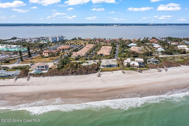 bird's eye view featuring a water view and a beach view