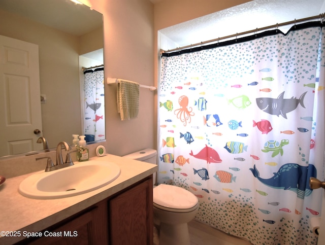 bathroom with vanity, toilet, and a shower with shower curtain