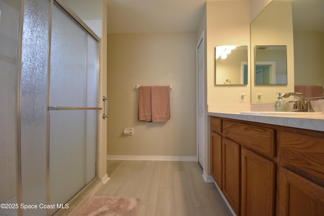 bathroom with vanity, hardwood / wood-style floors, and walk in shower