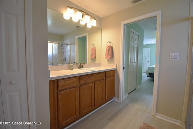 bathroom featuring vanity and an enclosed shower