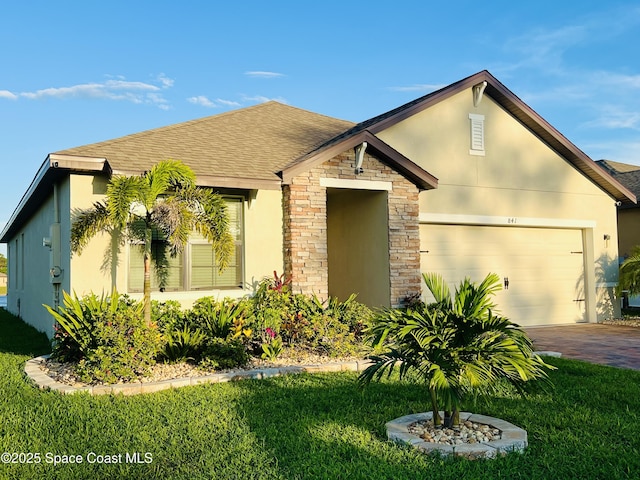 view of front of property featuring a garage and a front lawn