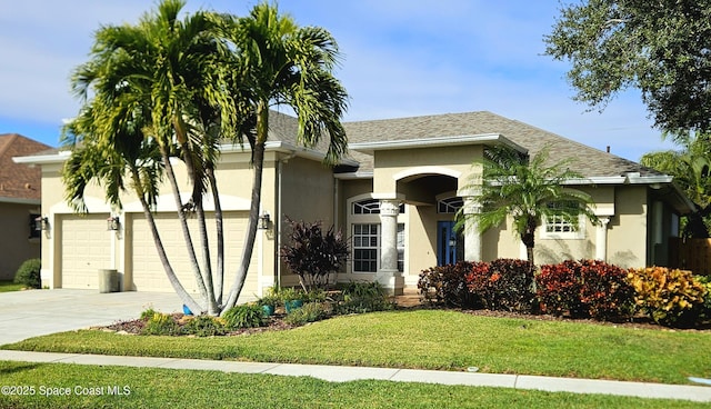 view of front of property with a garage and a front lawn