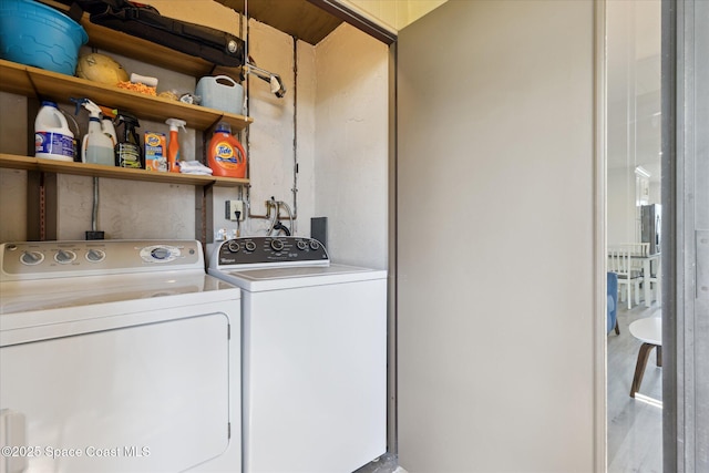 clothes washing area with independent washer and dryer