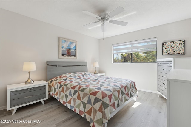 bedroom with ceiling fan and light hardwood / wood-style flooring