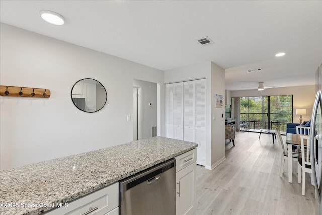 kitchen with white cabinetry, light stone countertops, stainless steel dishwasher, and light hardwood / wood-style floors