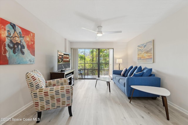 living room featuring light hardwood / wood-style flooring and ceiling fan