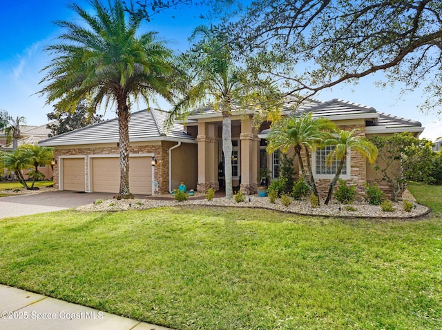 view of front of house with a garage and a front yard