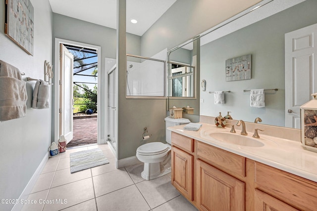 bathroom featuring tile patterned flooring, vanity, a shower with door, and toilet