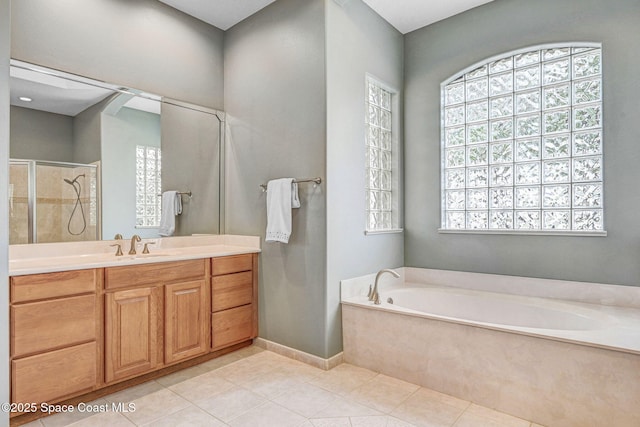 bathroom with vanity, tile patterned floors, and plus walk in shower