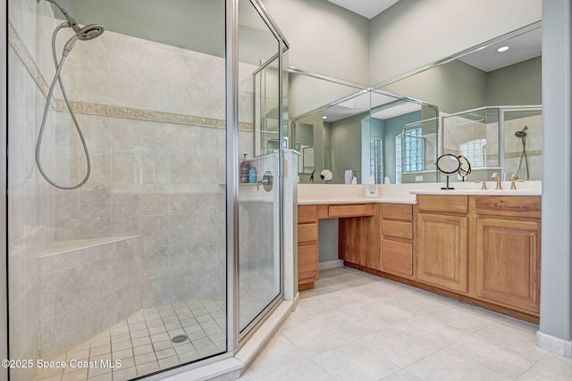 bathroom featuring tile patterned floors, vanity, and an enclosed shower