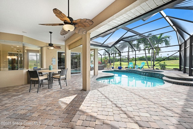 view of swimming pool with a patio area, an in ground hot tub, and glass enclosure