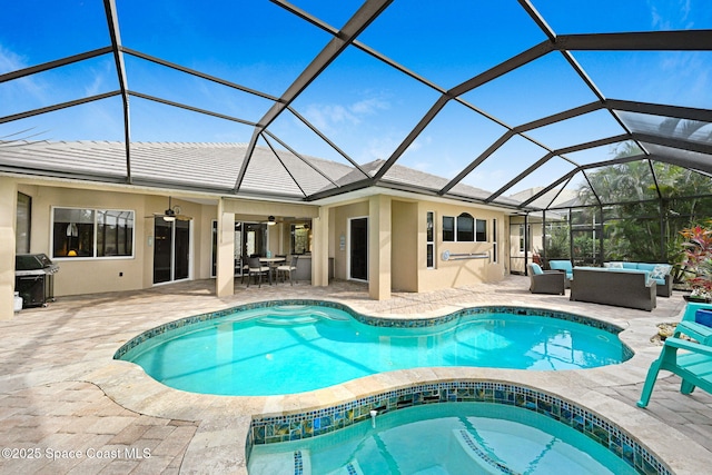 view of pool featuring a patio, an outdoor hangout area, ceiling fan, and glass enclosure