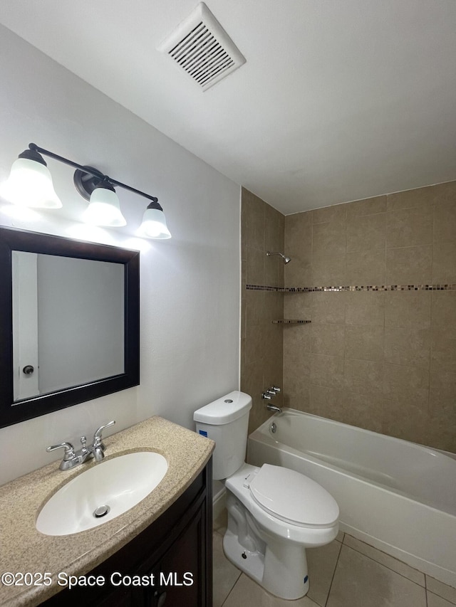 full bathroom with tile patterned floors, toilet, tiled shower / bath combo, and vanity