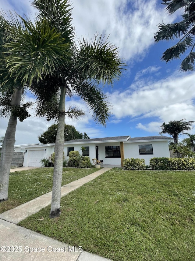 view of front of house featuring a garage and a front yard