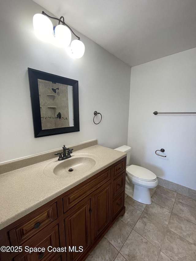 bathroom featuring tile patterned flooring, vanity, and toilet