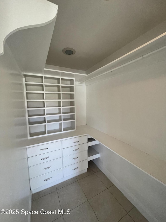 walk in closet with tile patterned floors