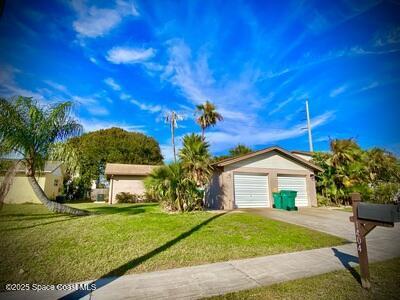 ranch-style home with a garage, concrete driveway, and a front yard