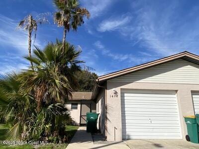 view of property exterior with driveway, an attached garage, and stucco siding