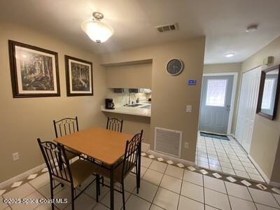 dining area featuring light tile patterned floors, visible vents, and baseboards