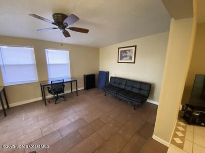 office space featuring ceiling fan and baseboards