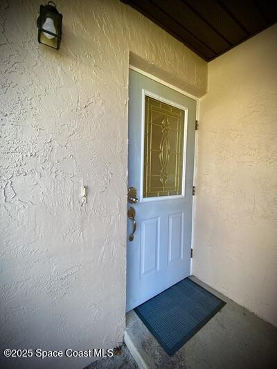 view of exterior entry with stucco siding