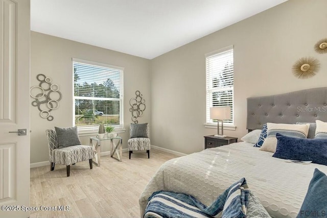 bedroom featuring light wood-style flooring and baseboards